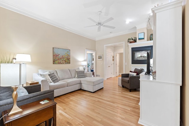 3283 Snaffle Rd, Lexington, KY 40513 - living room with crown molding, light wood-style flooring, ceiling fan, and a multi sided fireplace