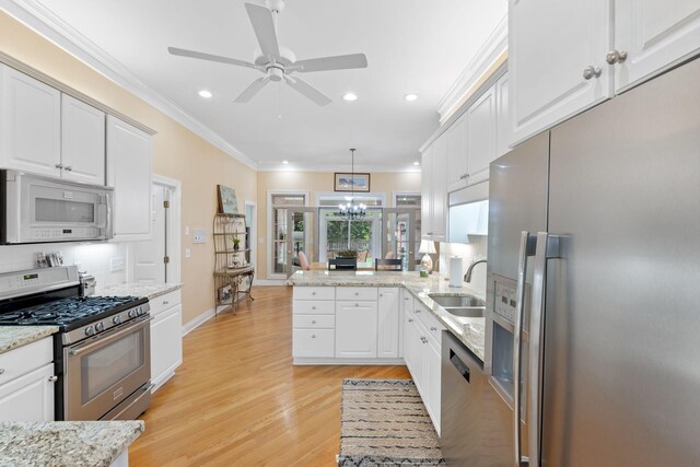 3283 Snaffle Rd, Lexington, KY 40513 - kitchen with stainless steel appliances, a sink, recessed lighting, a peninsula, and ornamental molding