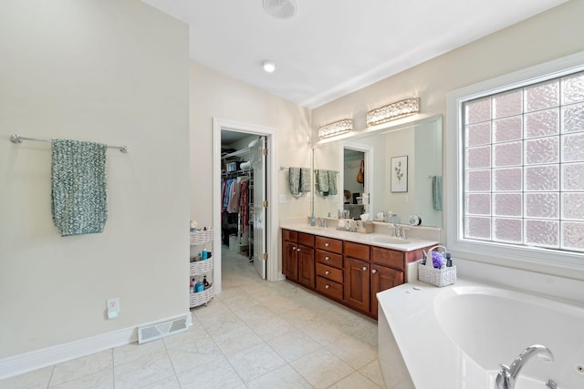 3283 Snaffle Rd, Lexington, KY 40513 - bathroom featuring double vanity, a whirlpool tub, a spacious closet, and baseboards