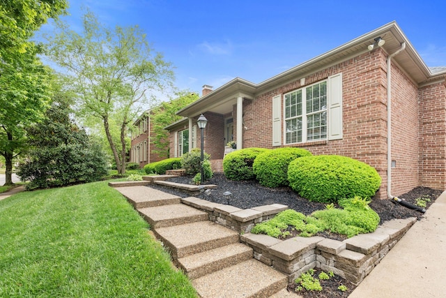 3283 Snaffle Rd, Lexington, KY 40513 - view of front facade featuring brick siding, a chimney, and a front lawn