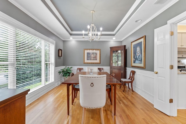 3283 Snaffle Rd, Lexington, KY 40513 - dining space with a chandelier, light wood finished floors, a raised ceiling, wainscoting, and crown molding