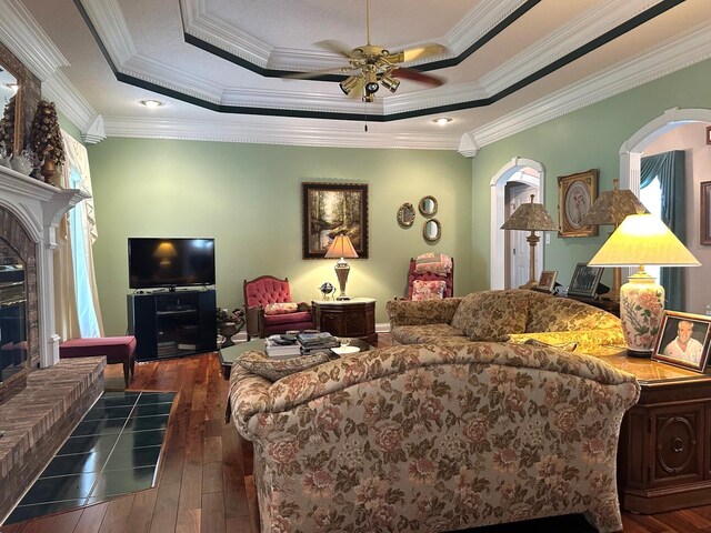 101 Wildwood Dr, Somerset, KY 42503 - living area featuring a ceiling fan, dark wood-style flooring, arched walkways, and a tray ceiling