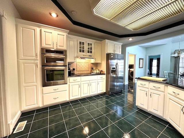 101 Wildwood Dr, Somerset, KY 42503 - kitchen featuring visible vents, dark countertops, dark tile patterned floors, tasteful backsplash, and appliances with stainless steel finishes