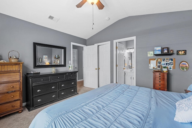 bedroom featuring light carpet, lofted ceiling, connected bathroom, and visible vents