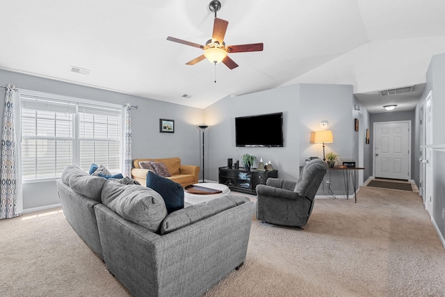 living room with visible vents, a ceiling fan, lofted ceiling, and light carpet