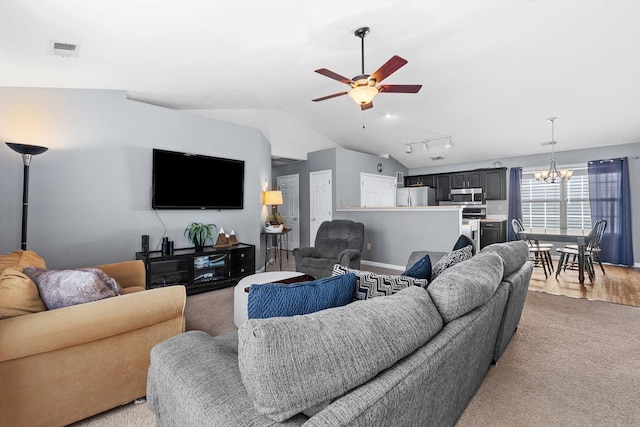 living area with visible vents, baseboards, ceiling fan with notable chandelier, lofted ceiling, and light carpet