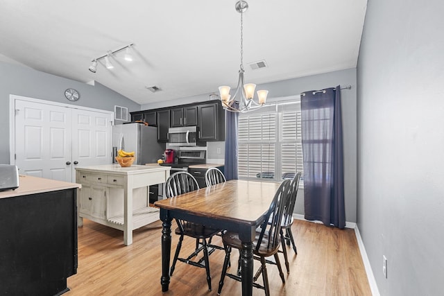 dining room with visible vents, a notable chandelier, and light wood-type flooring