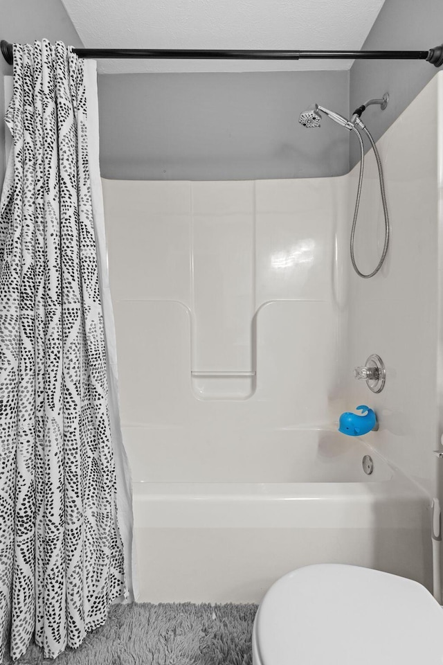 full bath featuring toilet and shower / bath combination with curtain