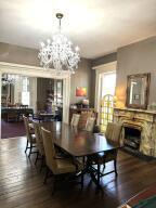 519 Ann St, Frankfort, KY 40601 - dining space featuring a fireplace, a notable chandelier, and dark wood finished floors