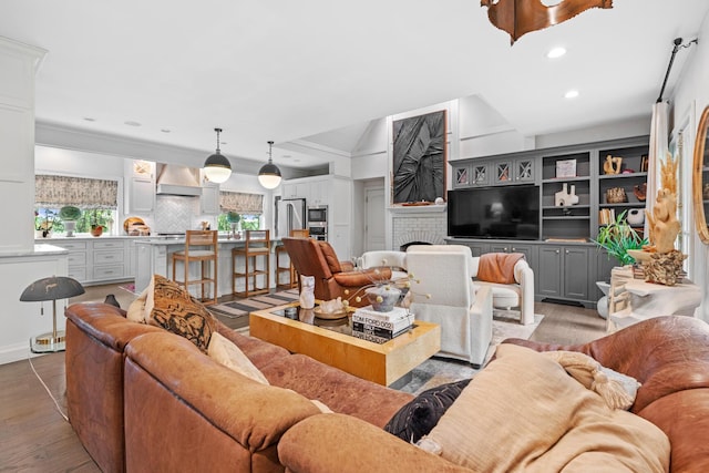 living room with light wood-type flooring and recessed lighting