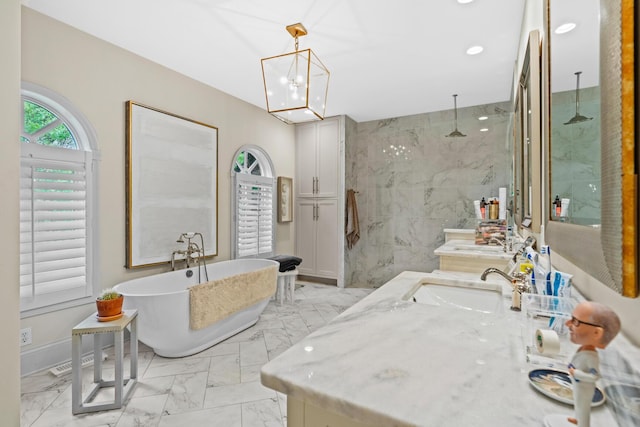 full bathroom featuring a freestanding bath, vanity, a marble finish shower, marble finish floor, and recessed lighting