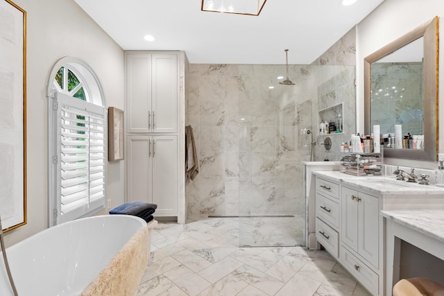 full bathroom featuring vanity, marble finish floor, a freestanding tub, recessed lighting, and a walk in shower