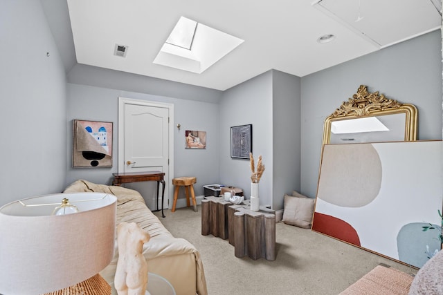 bedroom with a skylight, light carpet, attic access, and visible vents