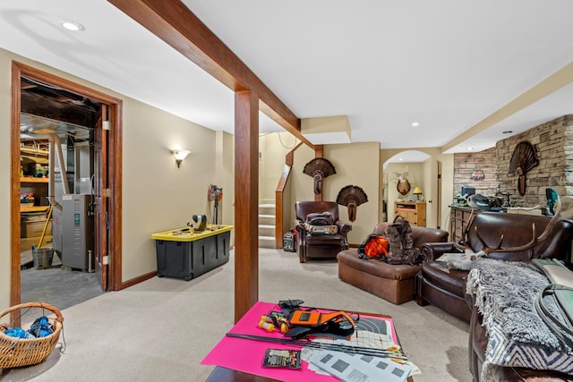 carpeted living room featuring arched walkways, baseboards, and recessed lighting