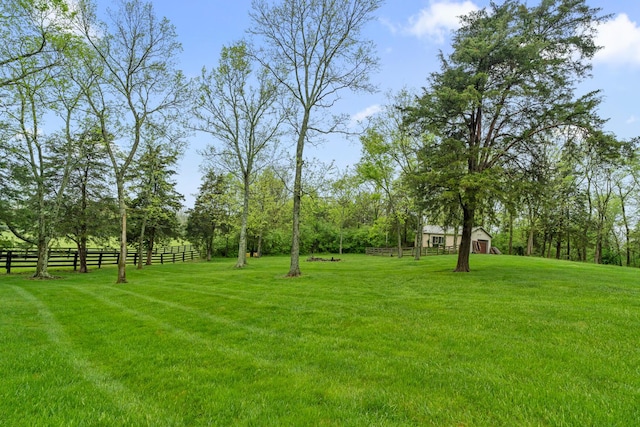 view of yard with fence and an outbuilding