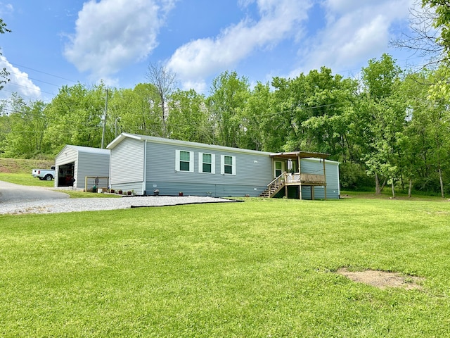 view of front of home with stairs, a garage, a deck, a front yard, and an outdoor structure