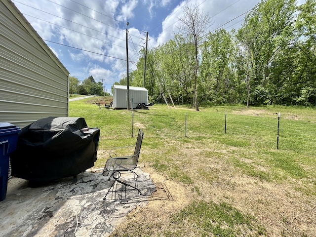 view of yard with an outbuilding and a shed