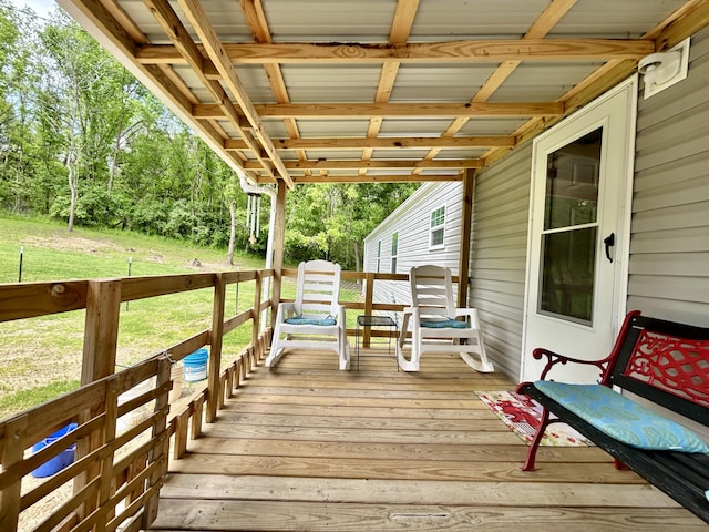 wooden deck with a lawn