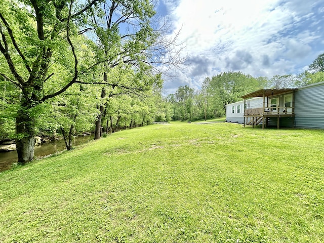 view of yard featuring a wooden deck and stairs