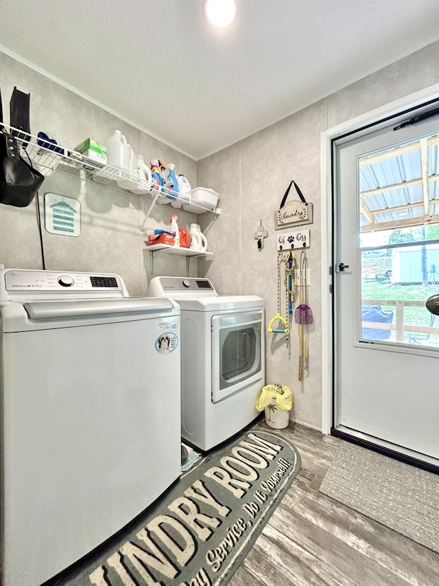 laundry room with separate washer and dryer, laundry area, and wood finished floors