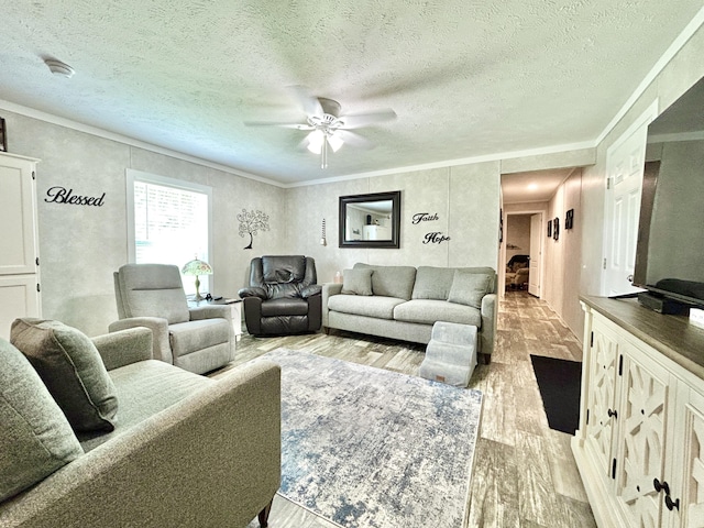 living room with light wood-style floors, ornamental molding, a textured ceiling, and ceiling fan