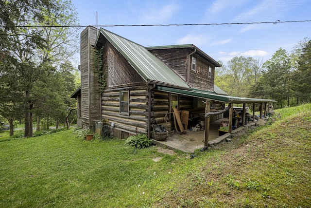 2616 Doylesville Rd, Richmond, KY 40475 - view of side of home featuring a lawn, log exterior, a chimney, and metal roof