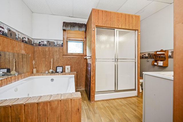 2616 Doylesville Rd, Richmond, KY 40475 - bathroom with vanity, a paneled ceiling, wood finished floors, a garden tub, and a stall shower