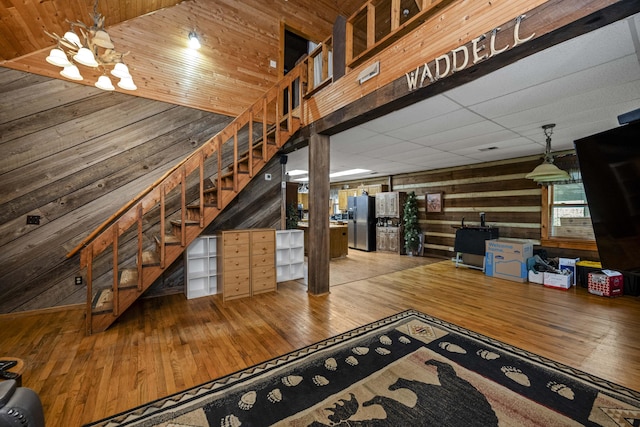 2616 Doylesville Rd, Richmond, KY 40475 - interior space with wooden walls, an inviting chandelier, hardwood / wood-style flooring, a drop ceiling, and stairway