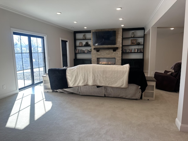 living area featuring crown molding, light colored carpet, a stone fireplace, built in features, and recessed lighting