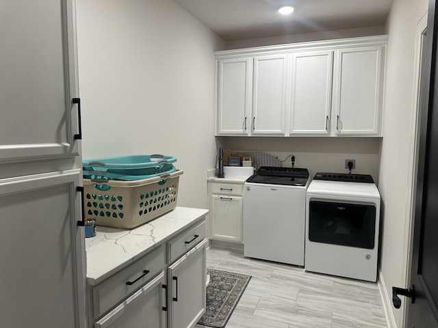 laundry room featuring washer and clothes dryer and cabinet space