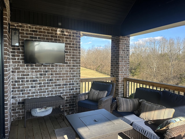 wooden deck with an outdoor living space