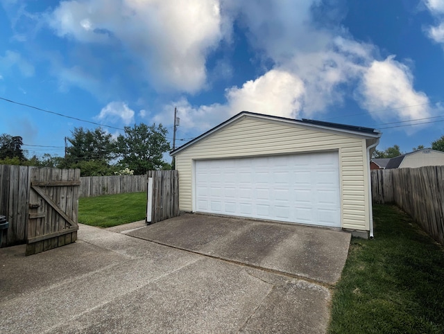 detached garage featuring fence