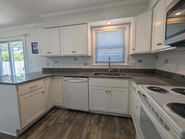 kitchen with ornamental molding, dark wood-style flooring, white appliances, white cabinets, and a sink