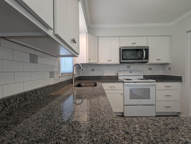 kitchen featuring electric range, a sink, white cabinets, stainless steel microwave, and dark stone countertops