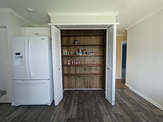 kitchen featuring baseboards, white fridge with ice dispenser, dark wood-style floors, and white cabinets