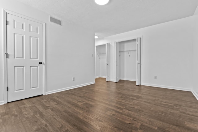 342 Prescott Rd, Paris, KY 40361 - unfurnished bedroom featuring two closets, dark wood-style flooring, baseboards, and visible vents