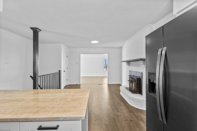 342 Prescott Rd, Paris, KY 40361 - kitchen with a brick fireplace, light countertops, white cabinetry, fridge with ice dispenser, and dark wood finished floors