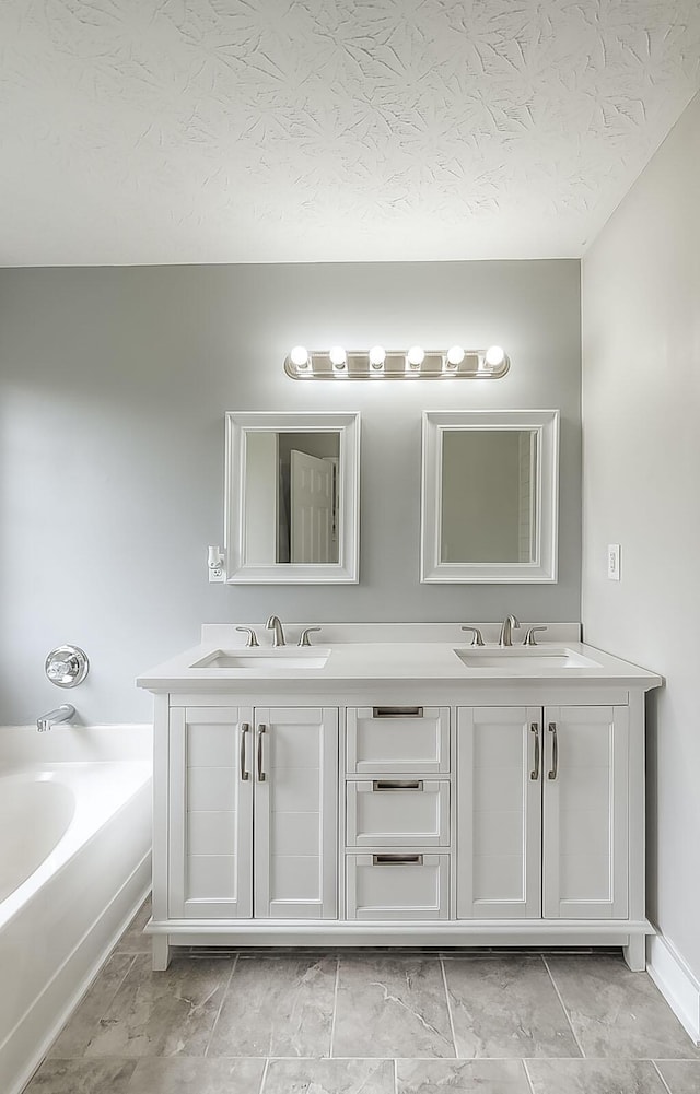 132 Mason Springs Dr, Nicholasville, KY 40356 - bathroom featuring a garden tub, double vanity, and a textured ceiling