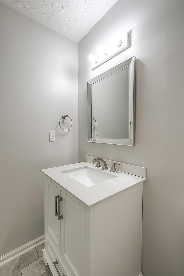 132 Mason Springs Dr, Nicholasville, KY 40356 - bathroom with vanity, baseboards, a textured ceiling, and marble look tiles