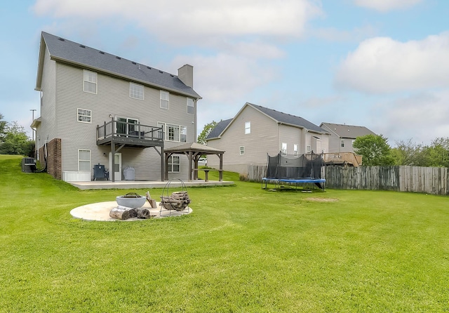 132 Mason Springs Dr, Nicholasville, KY 40356 - back of house with an outdoor fire pit, a gazebo, a trampoline, a chimney, and a patio