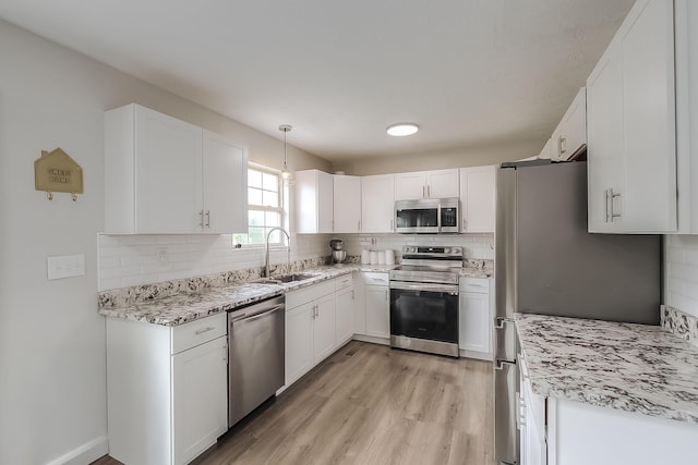 132 Mason Springs Dr, Nicholasville, KY 40356 - kitchen featuring stainless steel appliances, a sink, backsplash, white cabinetry, and light wood finished floors