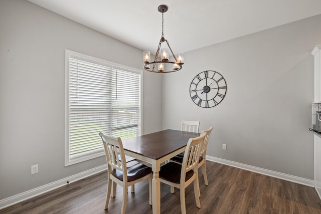 dining area featuring an inviting chandelier, baseboards, and plenty of natural light