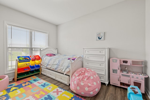 bedroom with dark wood-type flooring