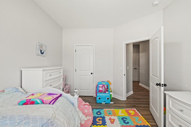 bedroom with baseboards and dark wood finished floors