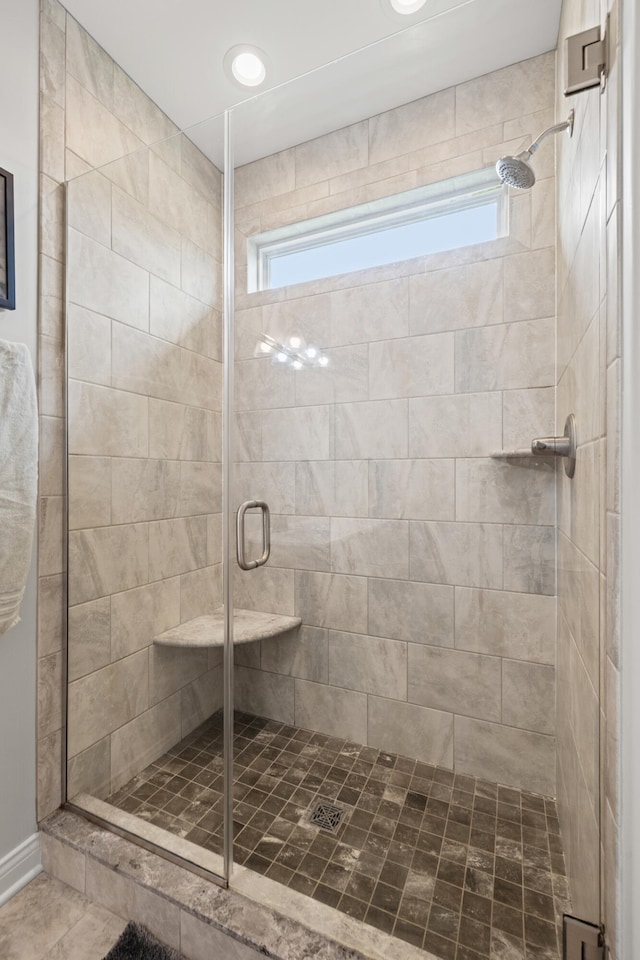 full bathroom featuring a stall shower and a healthy amount of sunlight