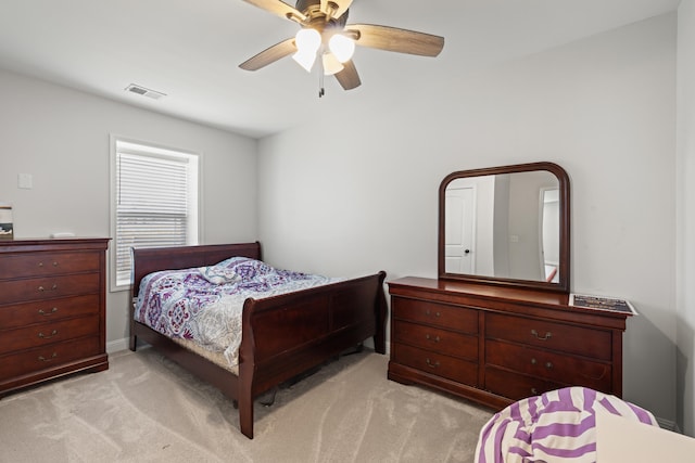 bedroom featuring ceiling fan, light colored carpet, and visible vents
