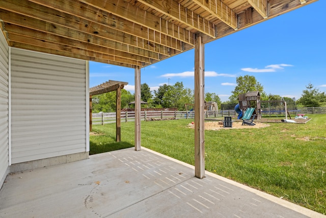 view of patio / terrace with a playground, a pergola, fence, and a trampoline