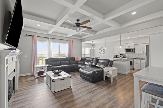 living room with beamed ceiling, a ceiling fan, recessed lighting, and wood finished floors