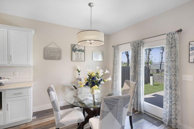 dining room with baseboards and wood finished floors