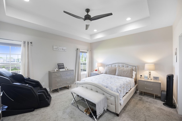 carpeted bedroom with recessed lighting, a tray ceiling, and ceiling fan